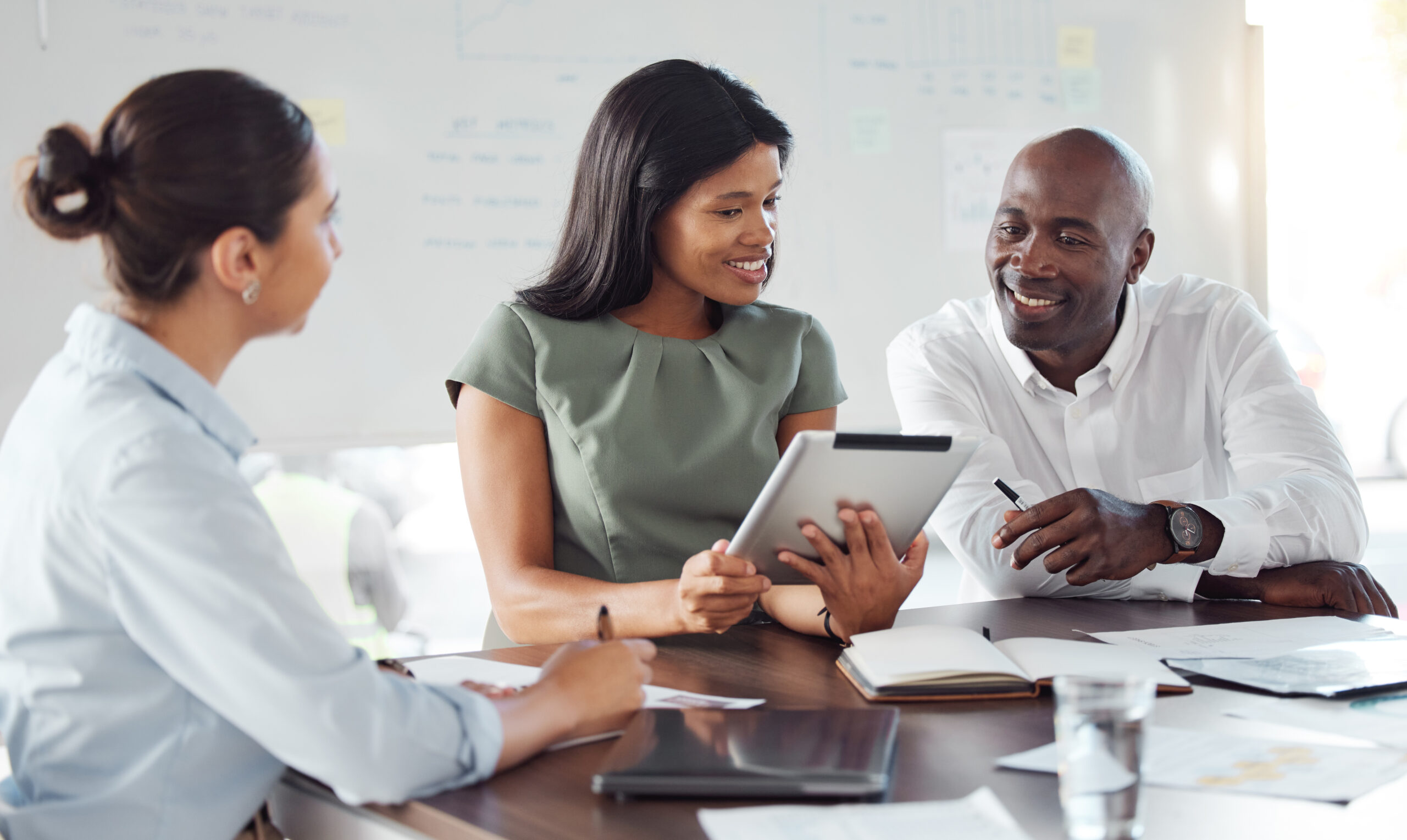Tablet and b2b business people or clients in meeting discussion to check website design, finance budget at marketing agency. Corporate manager smile for digital seo data or project management success marketers planning a digital marketing strategy