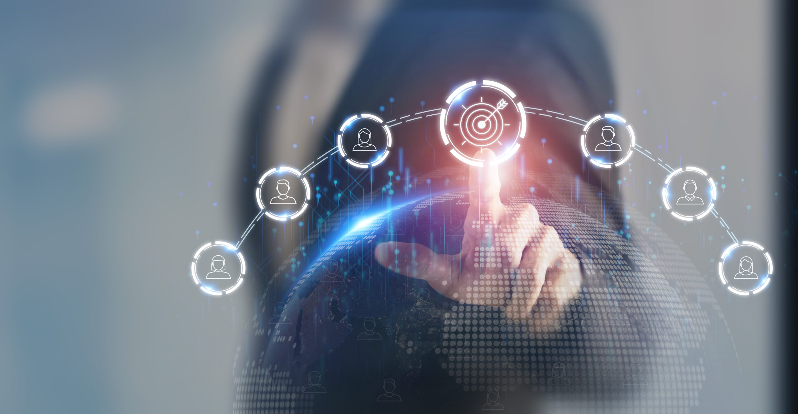 A person in a suit touches a target icon that is part of a superimposed group of digital icons.